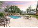 Backyard featuring a pool with fountains, a patio area, and manicured landscaping at 446 Piney Croft Ln, Maitland, FL 32751
