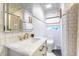 Bright bathroom featuring marble countertop, elegant sink, and white tiled walls and backsplash design at 446 Piney Croft Ln, Maitland, FL 32751