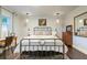 A bedroom with a metal bed frame, pendant lighting, and decorative wall paneling at 446 Piney Croft Ln, Maitland, FL 32751