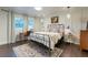 Cozy bedroom featuring a metal bed frame, pendant lighting, and a decorative wall at 446 Piney Croft Ln, Maitland, FL 32751