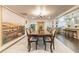 Elegant dining room with a long wooden table and chairs, featuring a large scenic mural and open access to the kitchen at 446 Piney Croft Ln, Maitland, FL 32751