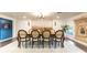 Elegant dining room with a decorative chandelier and seating for eight at 446 Piney Croft Ln, Maitland, FL 32751