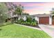 Stunning home with a well-manicured lawn and attractive brown garage door at 446 Piney Croft Ln, Maitland, FL 32751