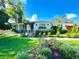 Charming home with a lush, green lawn and meticulously landscaped flower beds at 446 Piney Croft Ln, Maitland, FL 32751