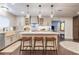 Updated kitchen featuring a central island, stylish pendant lights, and modern appliances at 446 Piney Croft Ln, Maitland, FL 32751