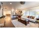 Spacious living room with white sofa, dark wood floors, and an open doorway to the dining room at 446 Piney Croft Ln, Maitland, FL 32751