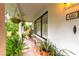 Inviting porch features potted plants and stone benches at 446 Piney Croft Ln, Maitland, FL 32751