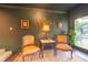 Cozy sitting area with two armchairs and a view of the backyard pool at 446 Piney Croft Ln, Maitland, FL 32751