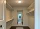 A well-organized walk-in closet featuring custom shelves and a convenient mirror at 446 Piney Croft Ln, Maitland, FL 32751