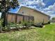 Well maintained backyard featuring a partially enclosed pool, healthy grass and manicured plants at 447 Cadiz Loop, Davenport, FL 33837