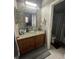 Updated bathroom featuring a glass bowl sink, stylish mirror, and neutral-toned mosaic backsplash at 447 Cadiz Loop, Davenport, FL 33837