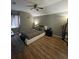 Bedroom with hardwood floors, ceiling fan, and stylish decor at 447 Cadiz Loop, Davenport, FL 33837
