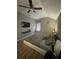 Bedroom with ceiling fan, faux-stone accent wall, and mounted television at 447 Cadiz Loop, Davenport, FL 33837