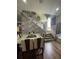 Elegant dining area with a modern table set and a stylish staircase backdrop, creating a sophisticated ambiance at 447 Cadiz Loop, Davenport, FL 33837