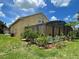 Home exterior featuring a screened in pool and backyard with lush landscaping and a grassy lawn at 447 Cadiz Loop, Davenport, FL 33837