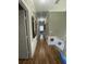 Hallway with hardwood floors and painted decor with a view into a sunlit room at 447 Cadiz Loop, Davenport, FL 33837