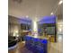 Modern kitchen features sleek countertops, stainless steel appliances, a central island with seating, and recessed lighting at 447 Cadiz Loop, Davenport, FL 33837