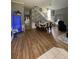 Open-concept living and dining area boasts sleek hardwood floors and a staircase with modern accents at 447 Cadiz Loop, Davenport, FL 33837