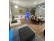Open-concept area with cozy seating and a dining area illuminated by elegant chandelier at 447 Cadiz Loop, Davenport, FL 33837