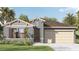 Charming single-story home with a neutral color palette, a two-car garage and lush landscaping at 4578 Boxwood Way, Mount Dora, FL 32757