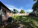 A brick house in a green backyard with wood fence at 5123 Turnbull Dr, Orlando, FL 32812