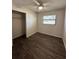 Bedroom with new plank flooring and natural light from window at 5123 Turnbull Dr, Orlando, FL 32812