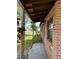 Brick home featuring covered front porch with iron supports and traditional outdoor lighting fixture at 5123 Turnbull Dr, Orlando, FL 32812
