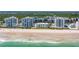 Aerial view of oceanfront condos along a sandy beach with blue ocean water at 5300 S Atlantic Ave # 6-502, New Smyrna Beach, FL 32169