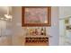 Bar area with a wine rack, countertop, decorative items, and a painting of a beach scene at 5300 S Atlantic Ave # 6-502, New Smyrna Beach, FL 32169