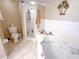 Bathroom featuring a shower, soaking tub, toilet, and decorative tropical accents at 5300 S Atlantic Ave # 6-502, New Smyrna Beach, FL 32169