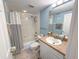 Bathroom featuring a vanity, sink, toilet, and shower with a black and white striped curtain at 5300 S Atlantic Ave # 6-502, New Smyrna Beach, FL 32169