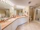 Bathroom featuring double sinks, tile floors, and a separate shower and bathtub at 5300 S Atlantic Ave # 6-502, New Smyrna Beach, FL 32169