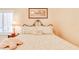 Bright bedroom showcasing a comfortable bed with decorative pillows and natural light from a window at 5300 S Atlantic Ave # 6-502, New Smyrna Beach, FL 32169