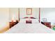 Bedroom featuring a four-poster bed, wooden bedside tables, and soft, neutral tones at 5300 S Atlantic Ave # 6-502, New Smyrna Beach, FL 32169