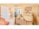Bright bedroom with a decorative metal bed frame and an open doorway to another room at 5300 S Atlantic Ave # 6-502, New Smyrna Beach, FL 32169