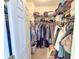 Walk-in closet with ample storage space, shelving, and hanging rods for organized clothing at 5300 S Atlantic Ave # 6-502, New Smyrna Beach, FL 32169
