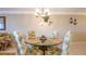 Bright dining area with a glass table and seating for four, complemented by coastal decor at 5300 S Atlantic Ave # 6-502, New Smyrna Beach, FL 32169