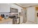 Kitchen with white cabinets and stainless steel appliances, offering efficiency and style for cooking enthusiasts at 5300 S Atlantic Ave # 6-502, New Smyrna Beach, FL 32169