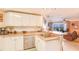 Open kitchen featuring modern appliances and a breakfast bar, seamlessly connected to the inviting living area at 5300 S Atlantic Ave # 6-502, New Smyrna Beach, FL 32169