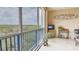 Screened-in lanai with seating and a view of lush greenery at 5300 S Atlantic Ave # 6-502, New Smyrna Beach, FL 32169