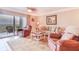 Living area with neutral tile flooring, comfortable seating, ceiling fan, and sliding glass doors to the patio at 5300 S Atlantic Ave # 6-502, New Smyrna Beach, FL 32169