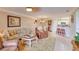 Open living and dining area featuring tile floors, comfortable seating, and a breakfast bar into the kitchen at 5300 S Atlantic Ave # 6-502, New Smyrna Beach, FL 32169