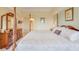 Spacious main bedroom with a four-poster bed, dresser, and ensuite bathroom at 5300 S Atlantic Ave # 6-502, New Smyrna Beach, FL 32169