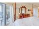Bedroom featuring a four-poster bed, vanity area, and sliding glass doors to the balcony at 5300 S Atlantic Ave # 6-502, New Smyrna Beach, FL 32169