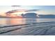 Calm ocean view with soft waves under a dramatic sky with vibrant sunset colors reflecting in the water at 5300 S Atlantic Ave # 6-502, New Smyrna Beach, FL 32169
