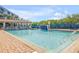Relaxing pool area featuring a waterfall, a covered seating area, and lounge chairs at 5300 S Atlantic Ave # 6-502, New Smyrna Beach, FL 32169