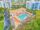 An aerial view of a community pool area featuring a pool, hot tub, and covered seating at 5300 S Atlantic Ave # 6-502, New Smyrna Beach, FL 32169
