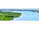 Picturesque waterfront view with lush green vegetation and boats sailing in the calm waters at 5300 S Atlantic Ave # 6-502, New Smyrna Beach, FL 32169