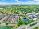 Expansive aerial view showcases the neighborhood's layout, community pool, pond, and surrounding lush landscape at 5464 Factors Walk Dr, Sanford, FL 32771