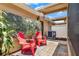 Charming backyard patio featuring two red Adirondack chairs and outdoor wall art at 5464 Factors Walk Dr, Sanford, FL 32771